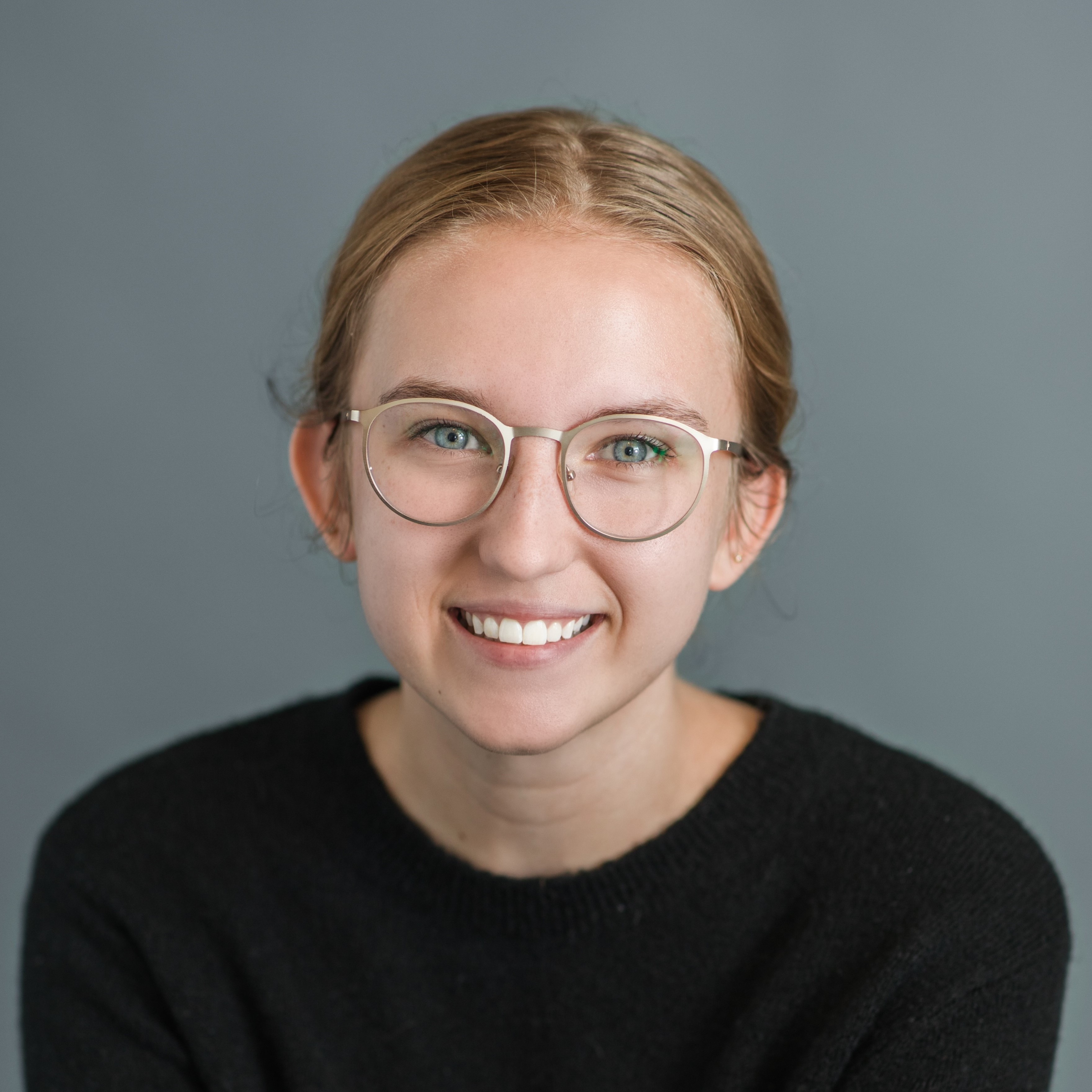 Headshot of woman in glasses smiling