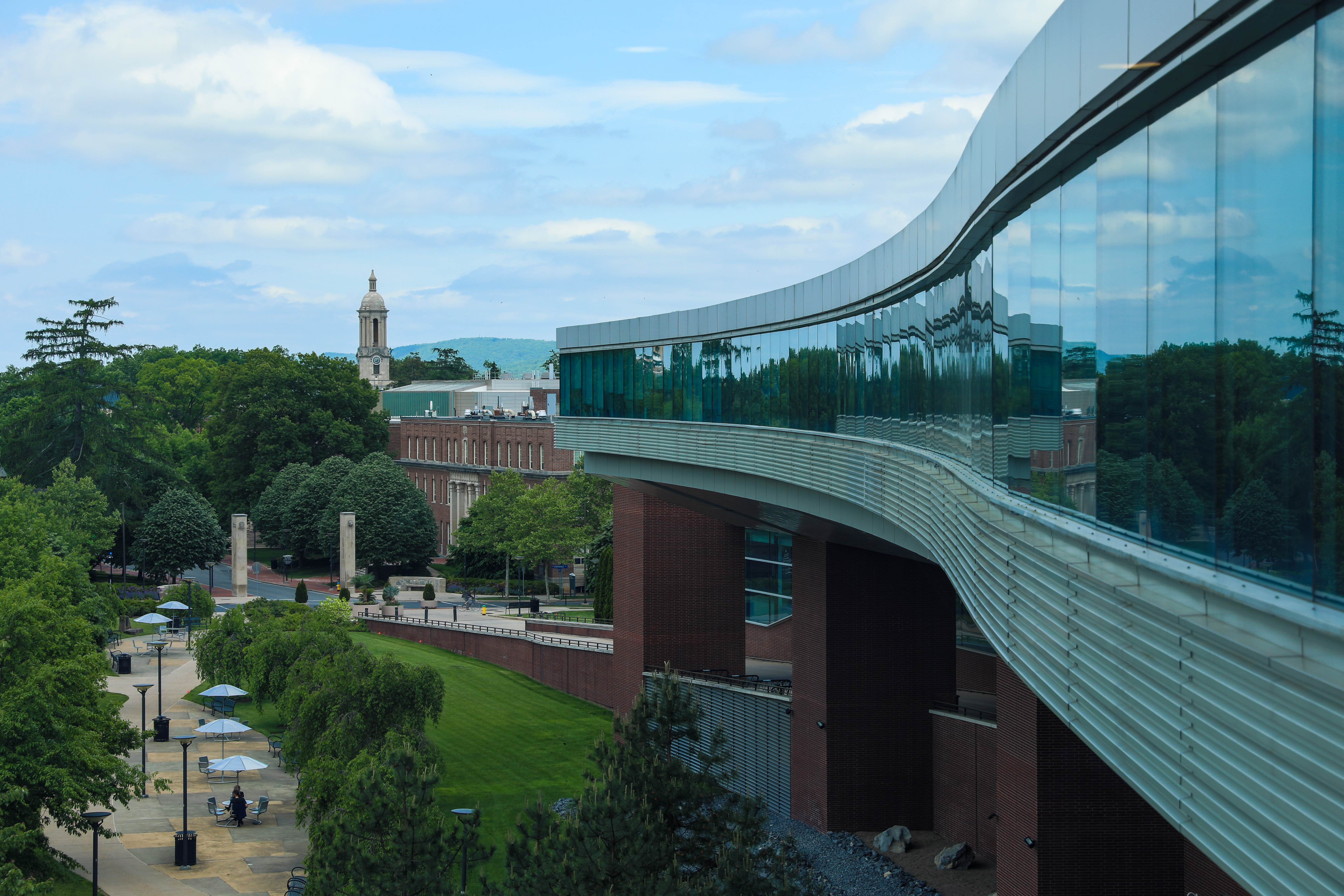 glass and brick campus building against blue sky