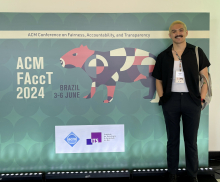 person standing next to science conference sign